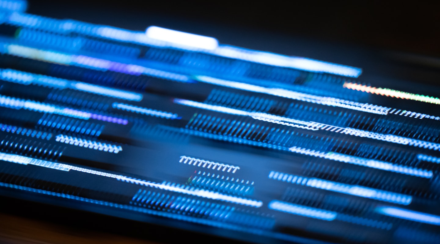 Blue and white light streaks flowing diagonally on a dark background.